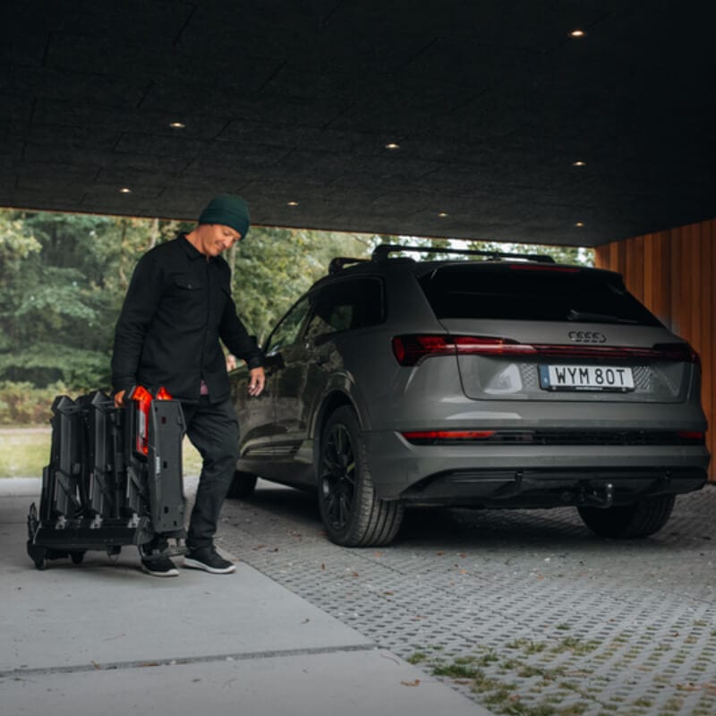 Man walking to fit a Bike Rack for Tow Bars onto his Audi